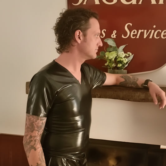 Man wearing a black Chlorinated Latex T-Shirt with a high-gloss finish by Latex and Lovers UK